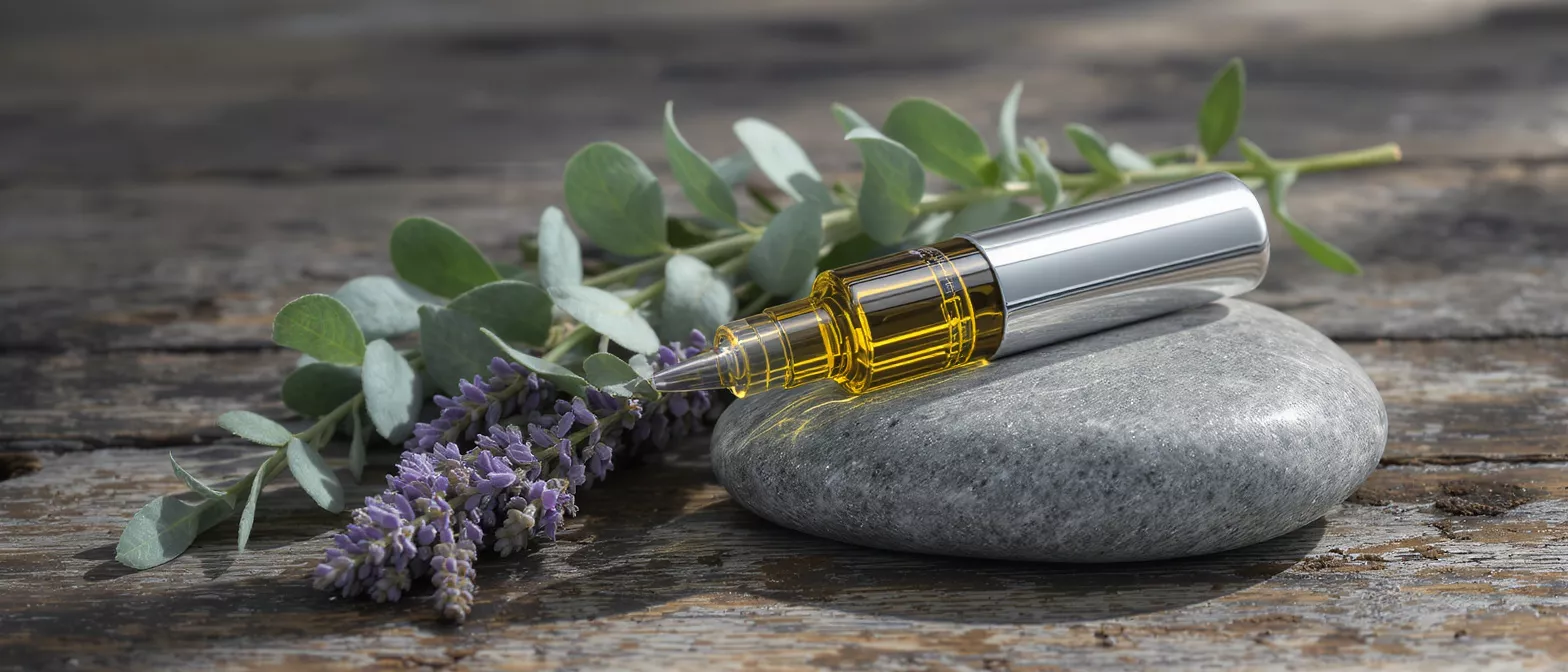 Lavender oil bottle placed on a smooth stone