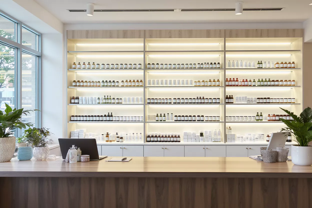 Modern Apothecary Store Interior Interior of a modern apothecary store with products on illuminated shelves.