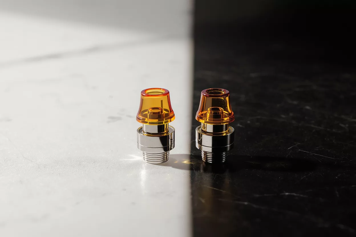 Two amber vape mouthpieces on a black and white split background.
