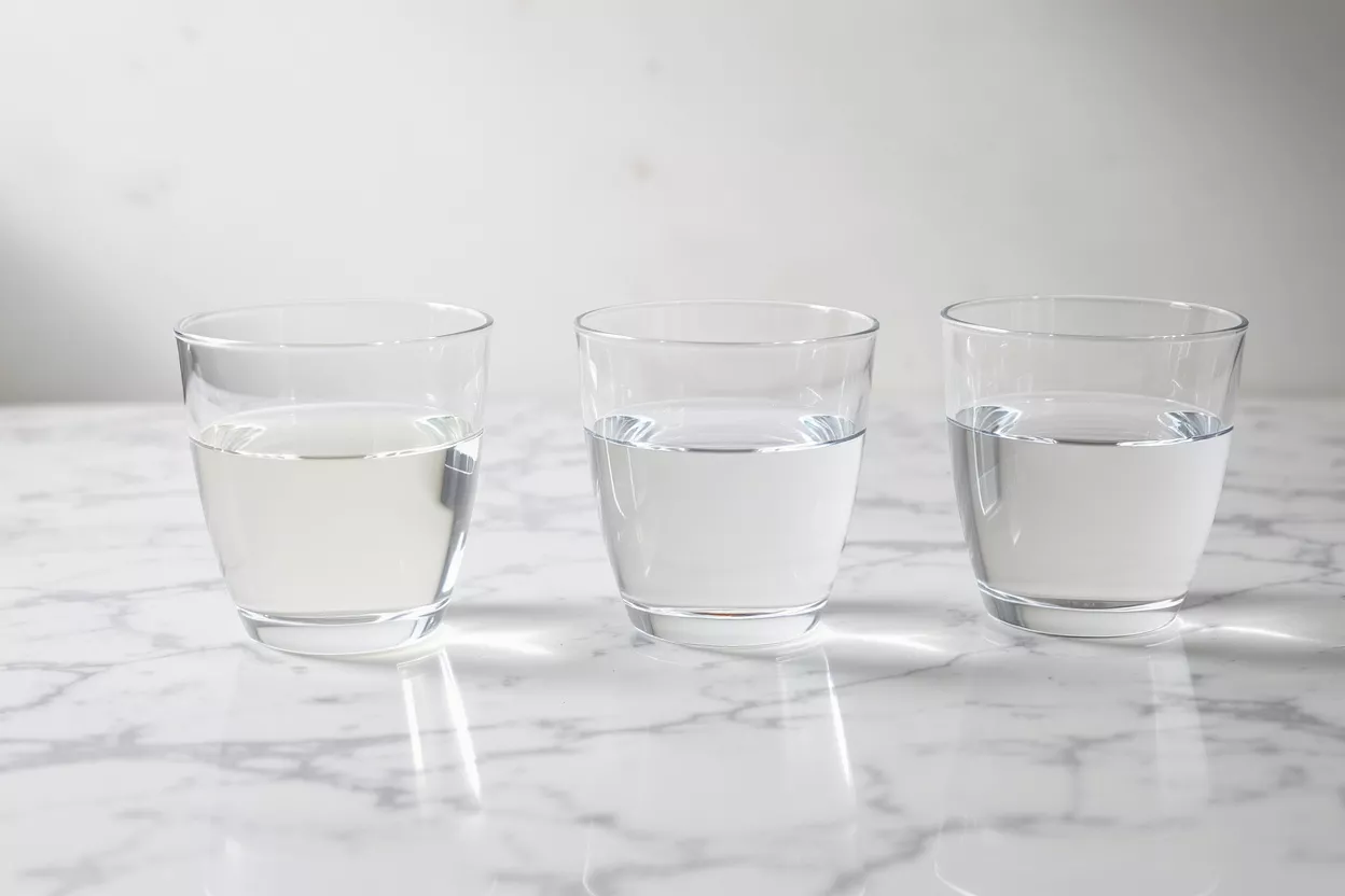 Three glasses of water on a marble surface