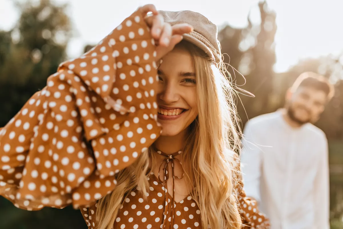 Young couple shares a playful moment in golden hour light, radiating joy and affection.