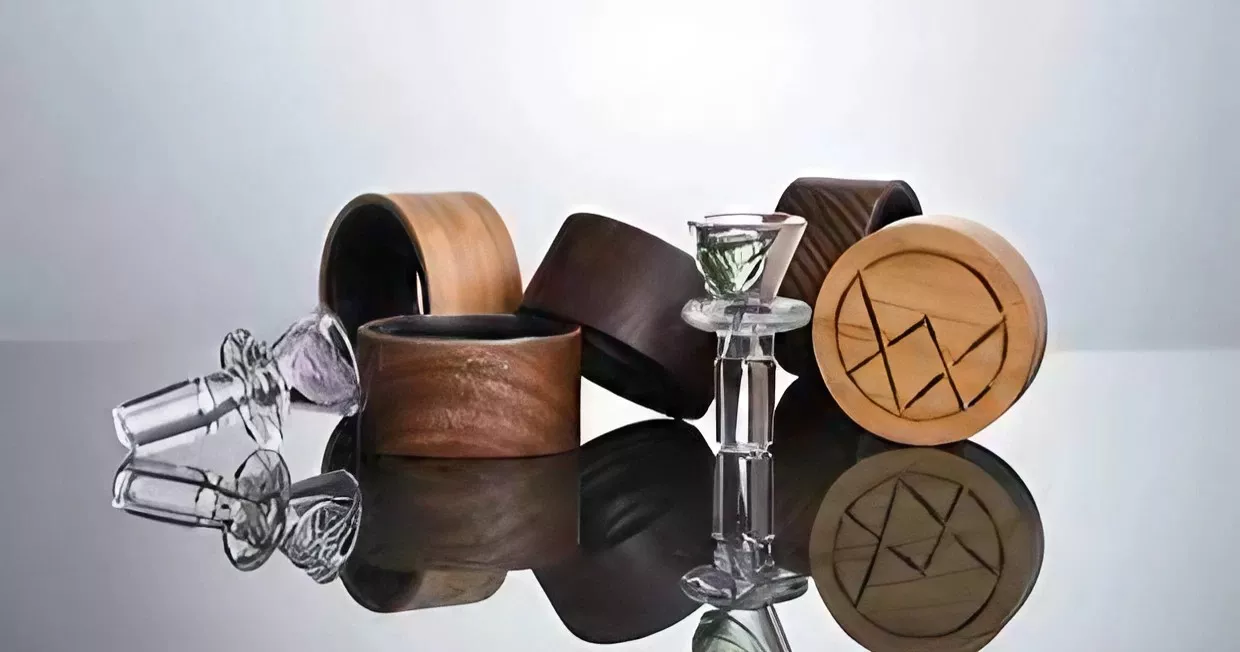 Assorted wooden and glass decor items displayed on a reflective surface.