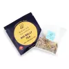 Tea packaging with a round yellow label, containing herbal tea blend.