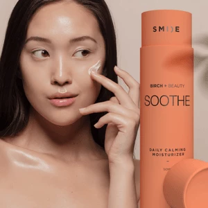 Woman applying Birch Beauty Soothe moisturizer