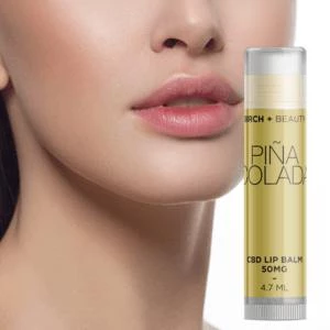 Close-up of lips with CBD lip balm tube