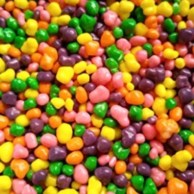 Close-up of glossy, colorful candy-coated sweets in assorted flavors.