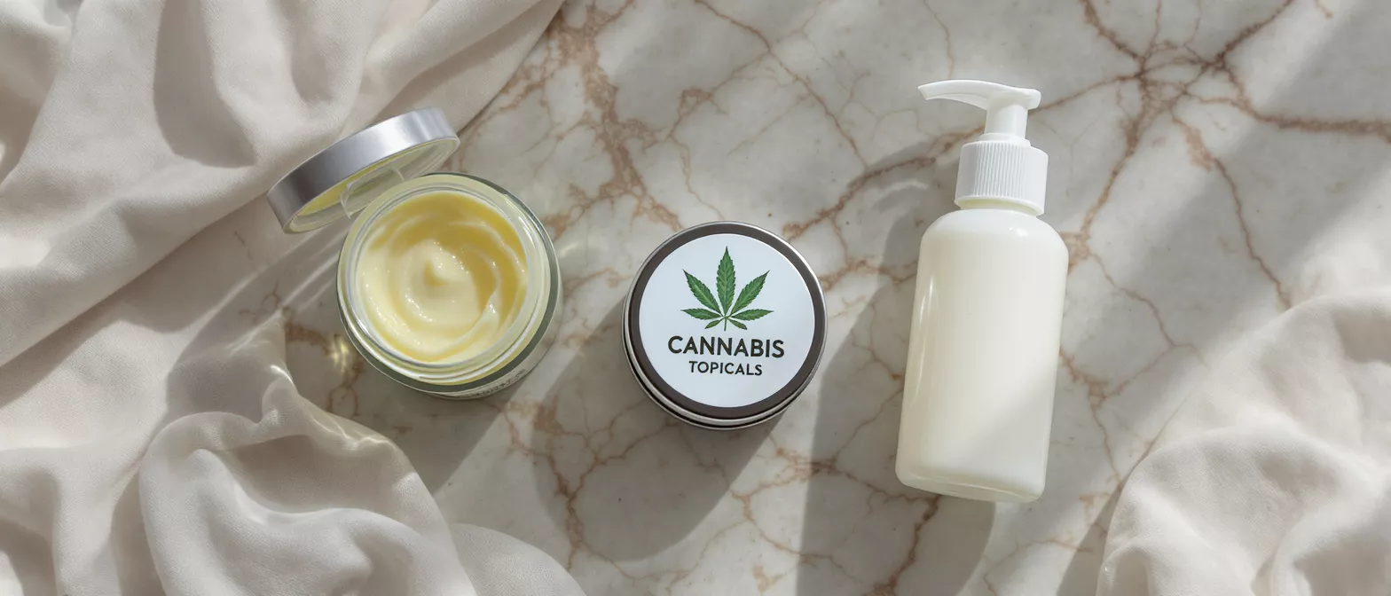 Cannabis Topicals Cream and Lotion Cannabis topical cream in jar, tin, and lotion bottle on marble with fabric.