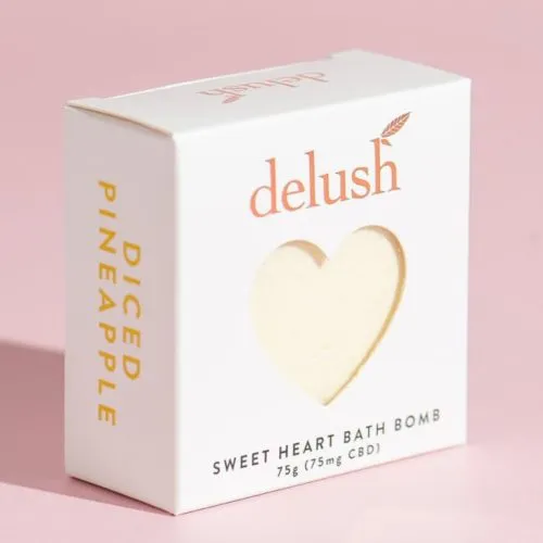 Delush Pineapple CBD Bath Bomb, 75g - Elegant White, Pink, and Gold Packaging.