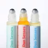 Duo Senses essential oil roll-on bottles in various colors and scents.