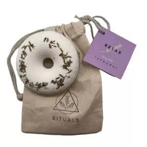 Aromatherapy lavender ring with CBD on a beige pouch.
