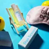 Relaxation and self-care items including deck chair, skincare bottle, sleep mask, stress ball, and box.