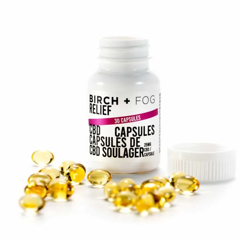 Birch + Fog 30 CBD Relief Capsules, 25mg each, with visible golden oil.