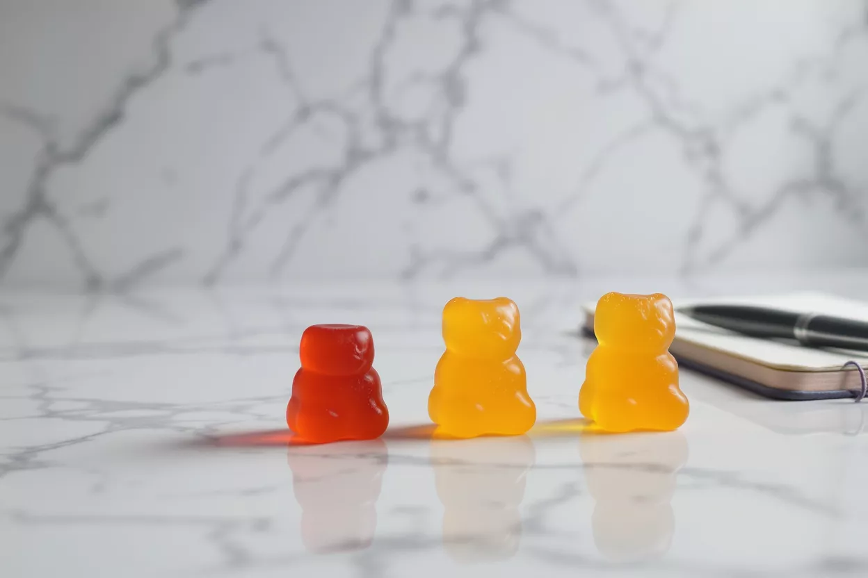 Three gummy bears in red and yellow colors
