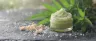 cbd exfoliating scrub in a glass jar with natural exfoliating particles