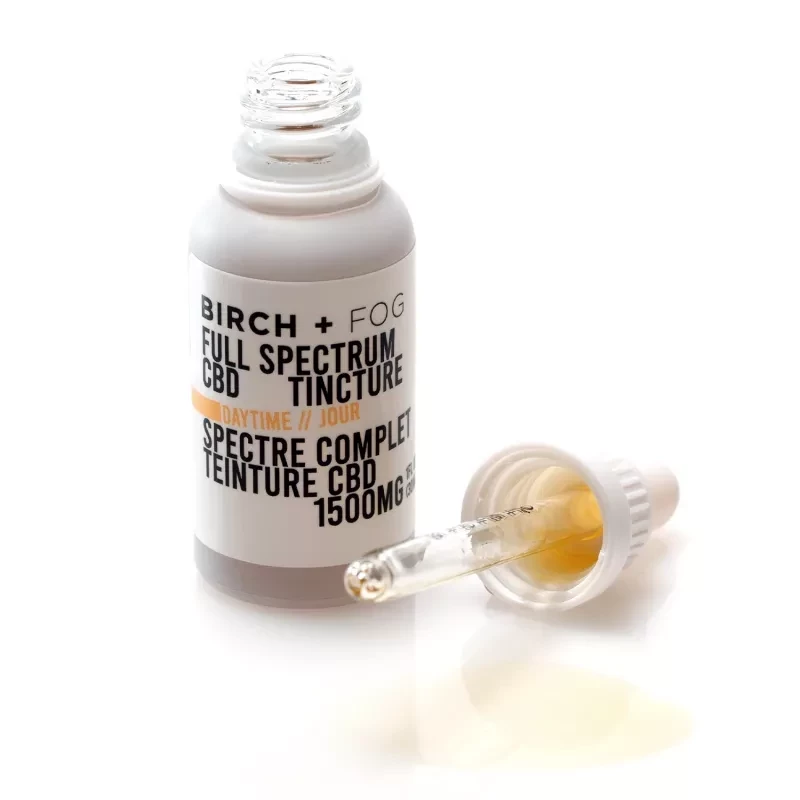 Birch + Fog Daytime 1500mg Full Spectrum CBD Tincture with dropper and spilled oil.