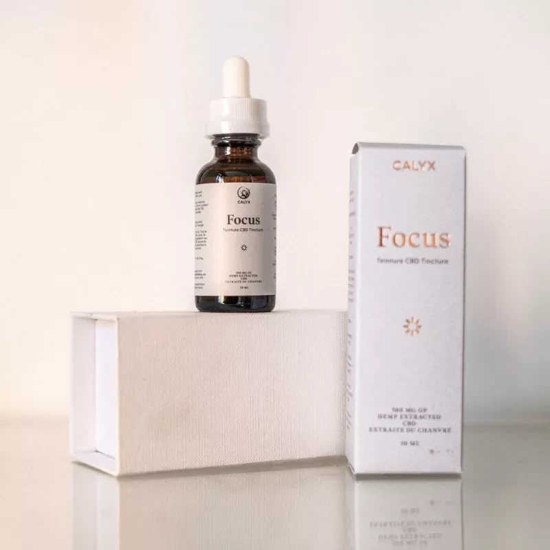 Calyx Focus CBD tincture bottle and box on reflective surface.