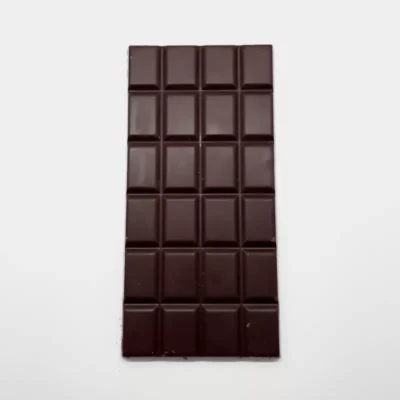 Premium dark chocolate bar with glossy finish and breakable grid squares, rich in cocoa flavor.