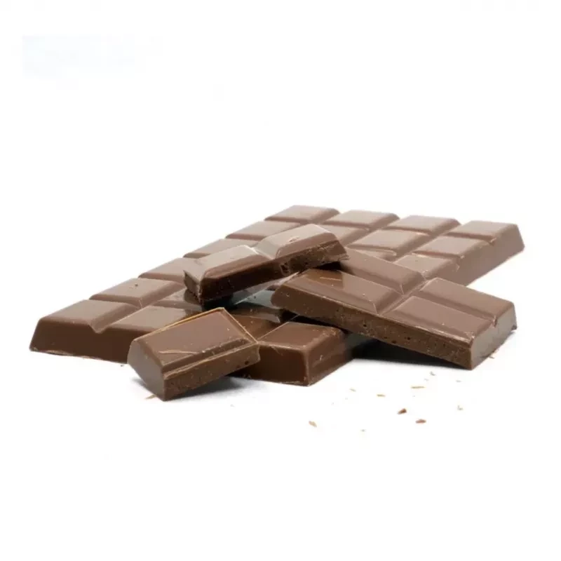 Creamy milk chocolate bar with broken pieces on a white surface.