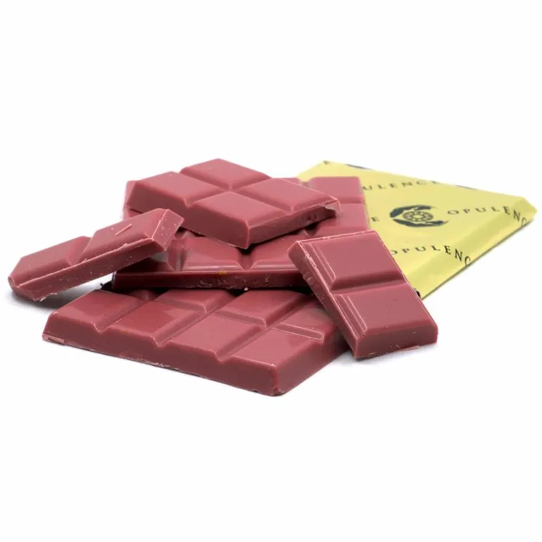 Glossy ruby chocolate pieces from Opulences Pink Champagne Bar with distinct pink hue.