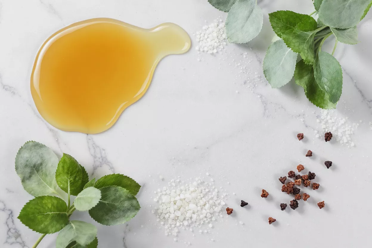 Honey, herbs, and spices on a marble surface