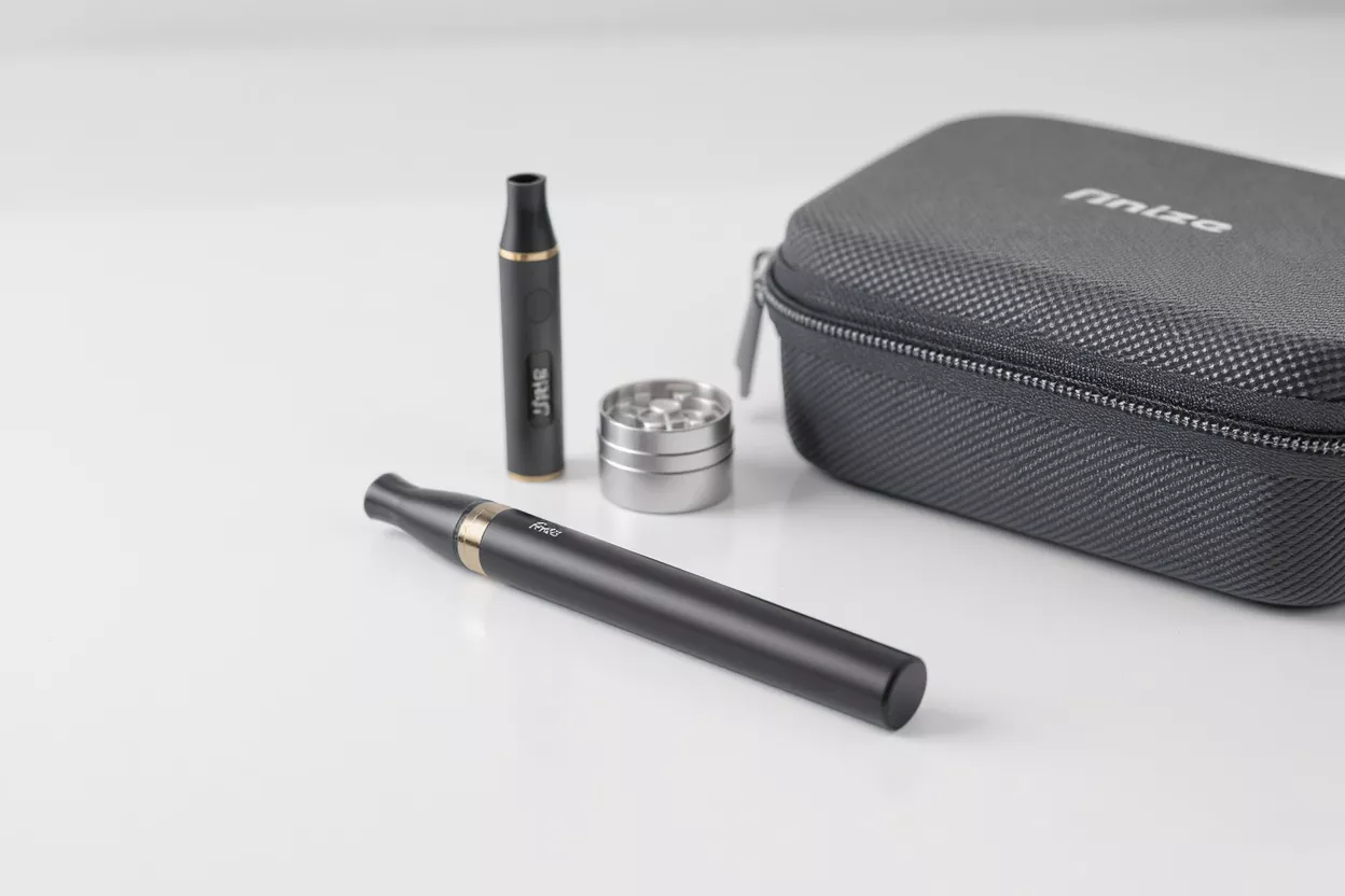 Vape Kit with Grinder and Case Black vape pens, silver grinder, and a black zippered case on a white background.