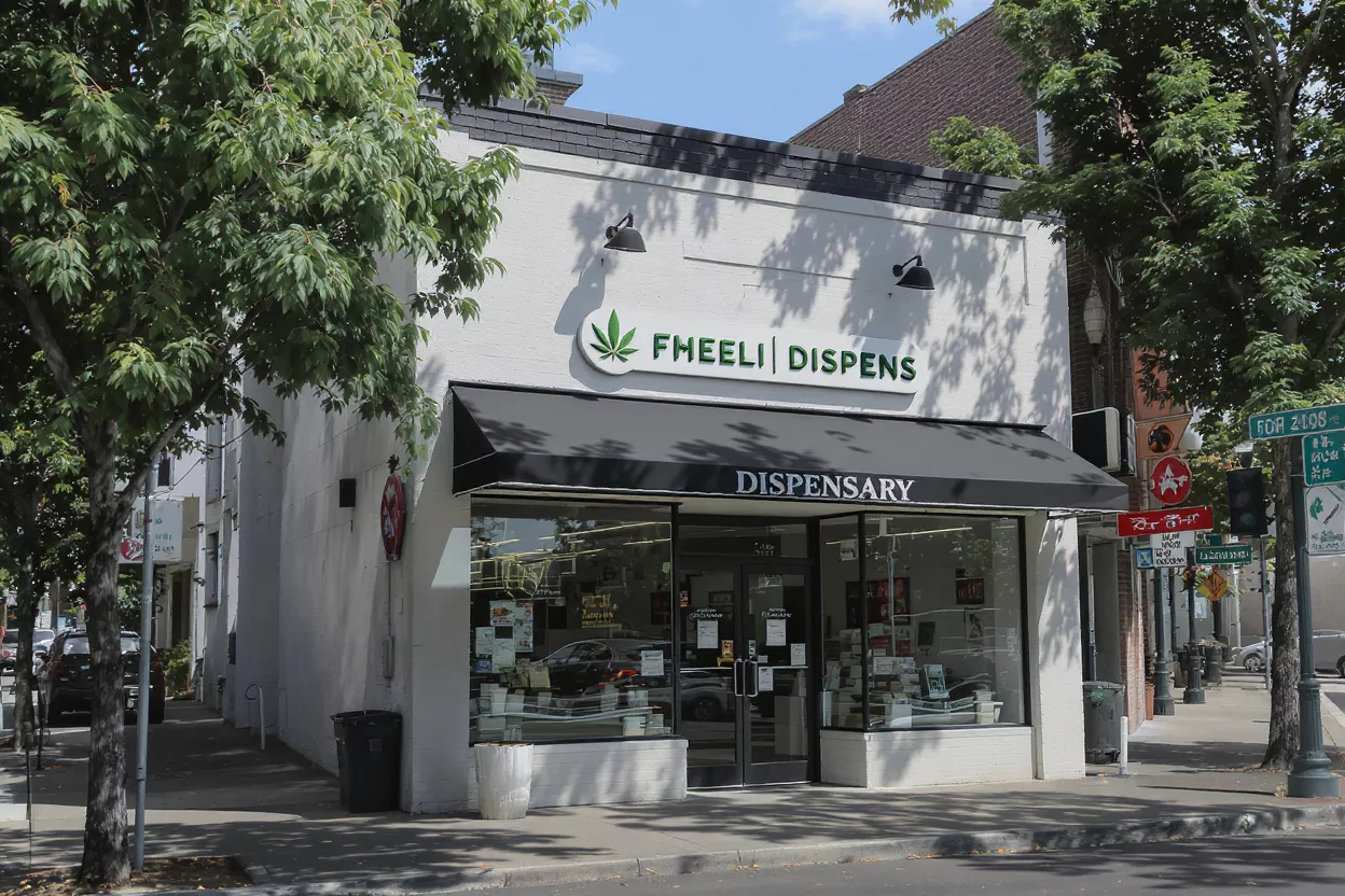 Fheeli Dispensary Storefront Exterior view of Fheeli Dispensary store with green sign and black awning.