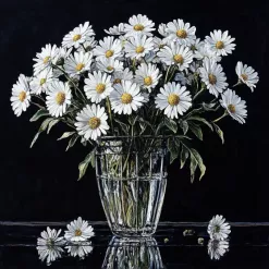 A bouquet of fresh daisies in a glass vase against a black background.