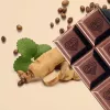 Chocolate with heart imprint, ginseng root, coffee beans, and green leaf for a natural indulgence.