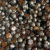 Luxurious dark chocolate candies with glossy sheen and sugar dusting.