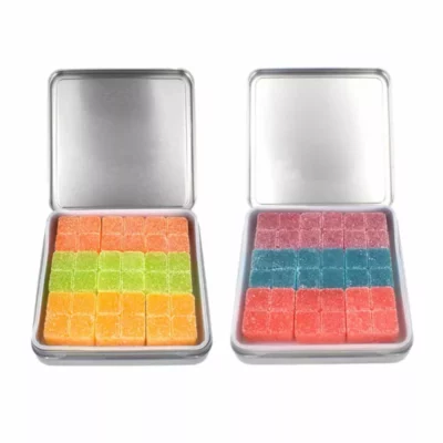Colorful Bliss Daydream THC-infused gummies in metal tins, with orange, green, pink, and blue squares.