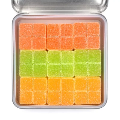 Colorful Bliss Sweetescape THC gummy candies in gradient orange and green squares.