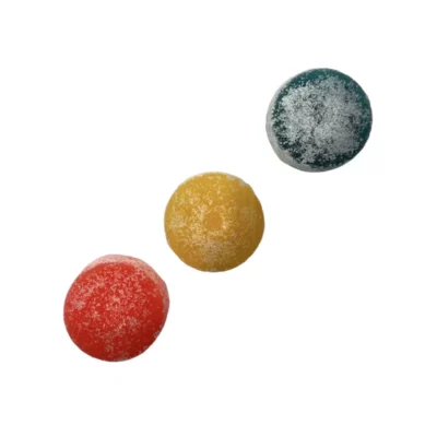 Colorful red, yellow, and blue CBD gummies with sugar coating isolated on white background.
