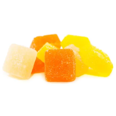 Assorted citrus and tropical flavored sugared jelly candies on white background.