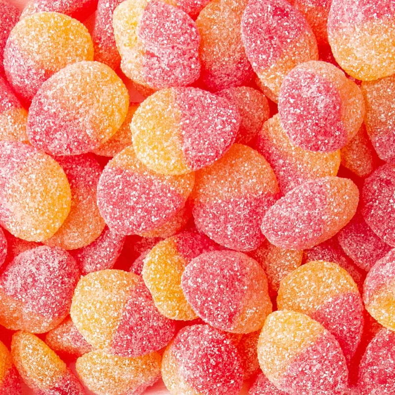 Close-up of sparkling, sugar-coated gummy candies in citrus and berry flavors.