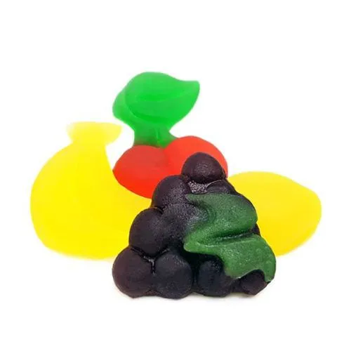 Colorful gummy candies shaped like grapes, cherries, and a pear on white background.