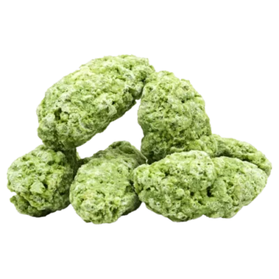 Six homemade, crumbly green no-bake cookies, likely matcha or pistachio-flavored, stacked on a plain background.