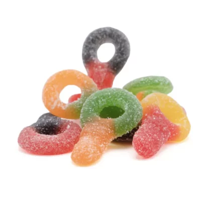 Colorful assortment of sugar-coated sour gummy candies in fruit shapes on white background.