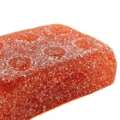 Glistening red strawberry-flavored gummy candy with a sugary crunch.