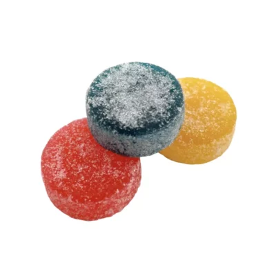Colorful stack of sour, sugar-coated CBD gumdrops in blue, red, and yellow on white background.