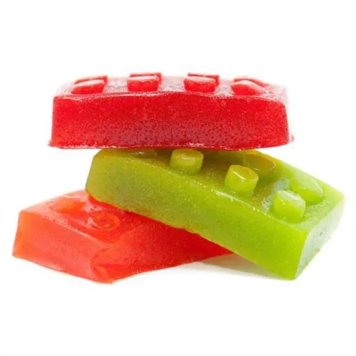 Colorful stackable MOTA sugar-free gummy blocks with LEGO-like design for interactive snacking.