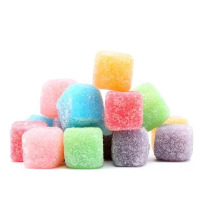 Assorted sour CBD gummies, sugar-coated and fruit-flavored candy squares.