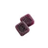 Two square purple sugar-coated gummies on a white background.