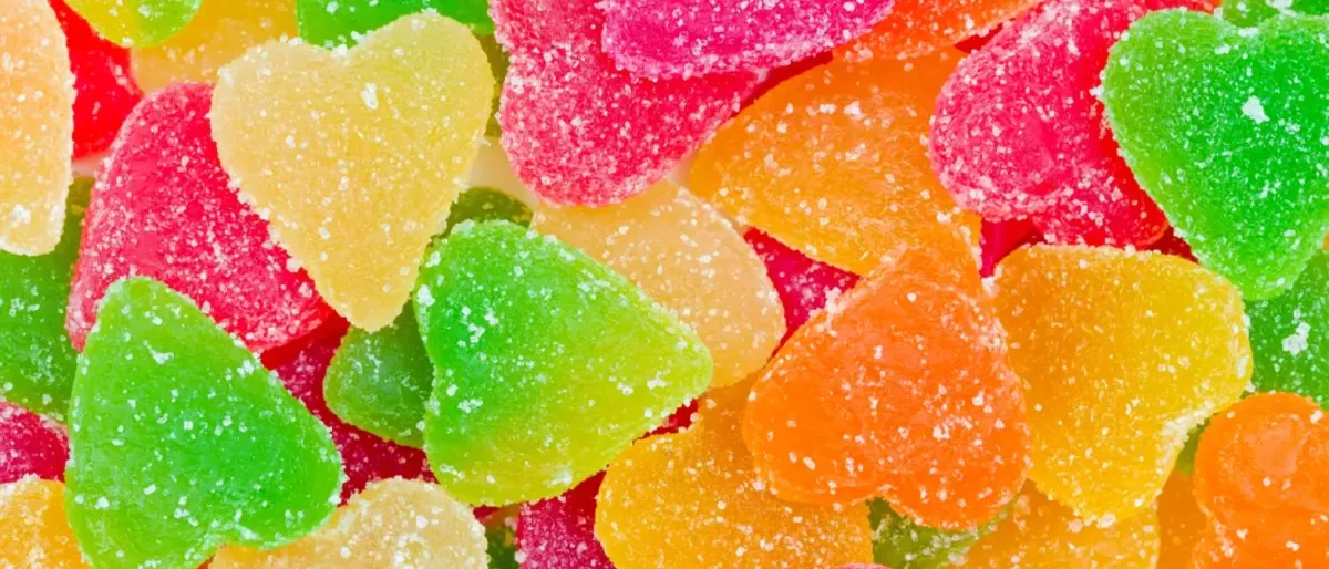 Colourful CBD gummies arranged on a white surface