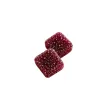Two square, dark red berry-flavored gummies coated in sugar on a white background.