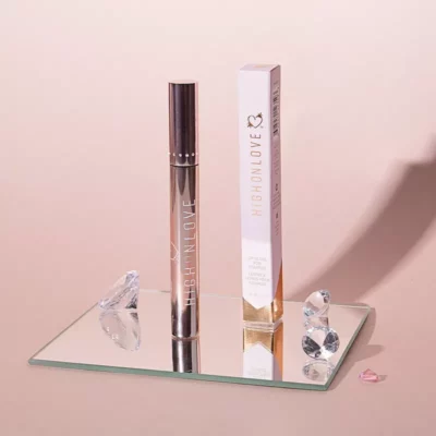HighOnLove Luxe Lip Gloss - Sophisticated, Plumping Cosmetic on Elegant Glass Display.