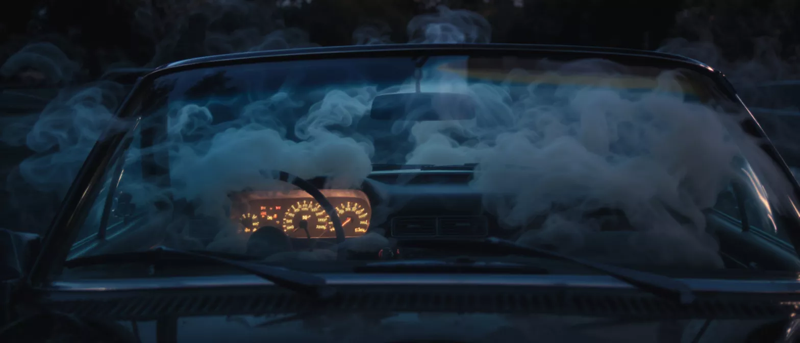 Smoke filling the interior of a car dashboard