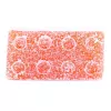 Orange gummy candy with sugar coating and circular indentations.