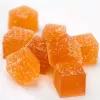 Vibrant orange gummy candies in various shapes