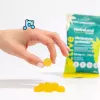Yellow gummies on hand with turquoise packaging, marketed for active lifestyle snacks.