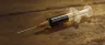 Dark viscous phoenix tears cannabis oil in a syringe